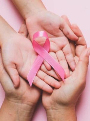 Woman-Hands-Holding-Pink-Ribbon-Pink-Background-Breast-Cancer-Awareness-October-Pink-Concept