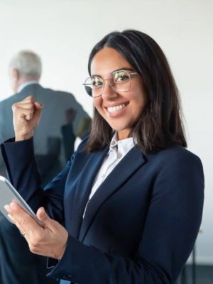 Cropped-Happy-Female-Professional-Glasses-Suit-Holding-Tablet-Making-Winner-Gesture-While-Two-Businessmen-Working-Glass-Wall-Copy-Space-Communication-Concept.jpg